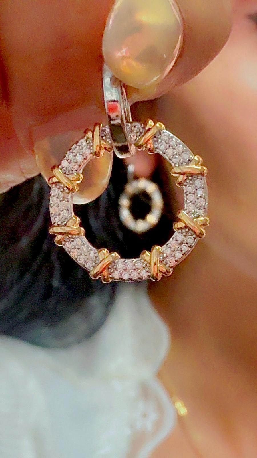 Gold and silver sparkling circle earrings with crystal accents displayed on ear