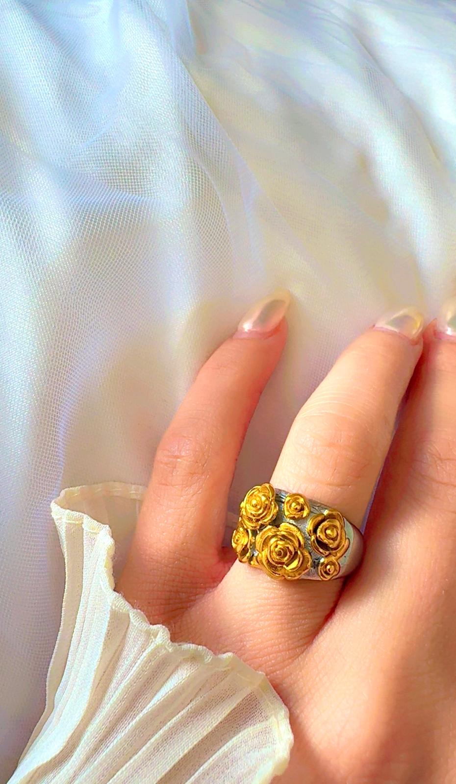 Close-up of floral rose cluster ring in polished gold finish