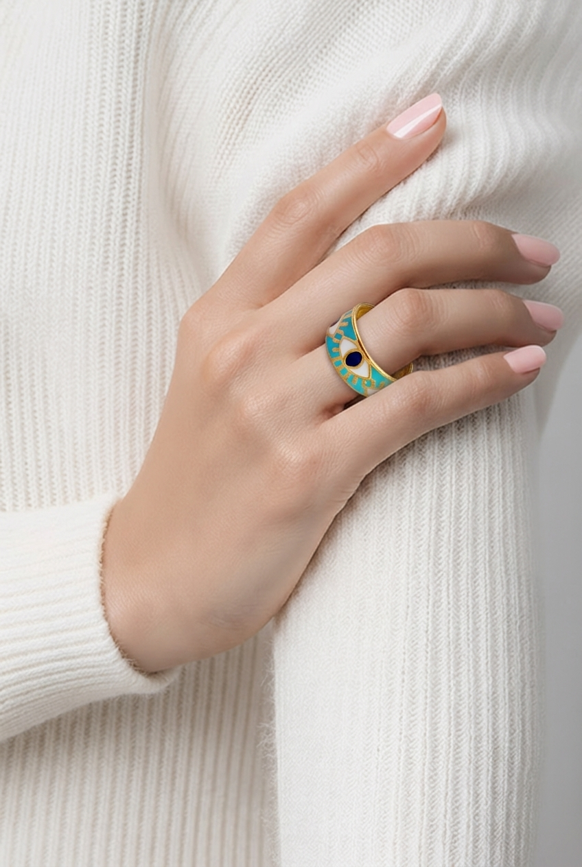 Hand wearing gold ring on a white background