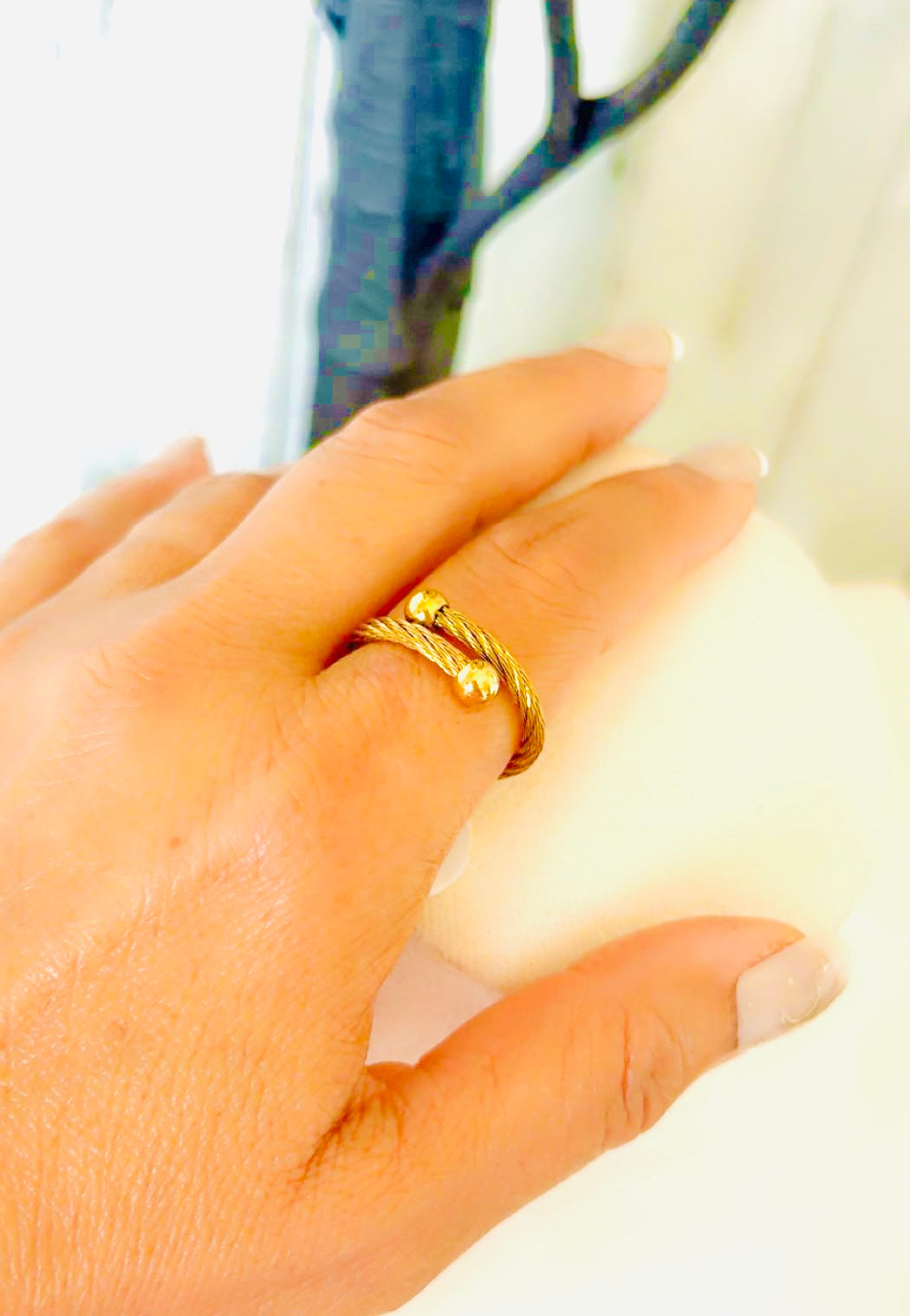 Gold twisted cable ring with rope design and polished ball ends