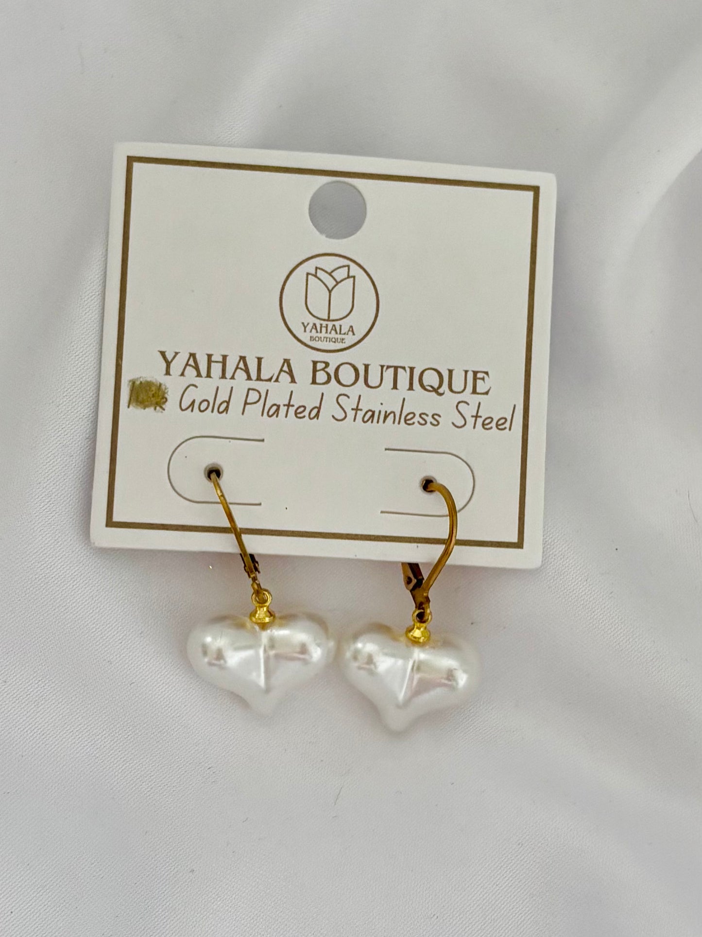 Heart-shaped earrings on a Yahala Boutique card with gold plating.