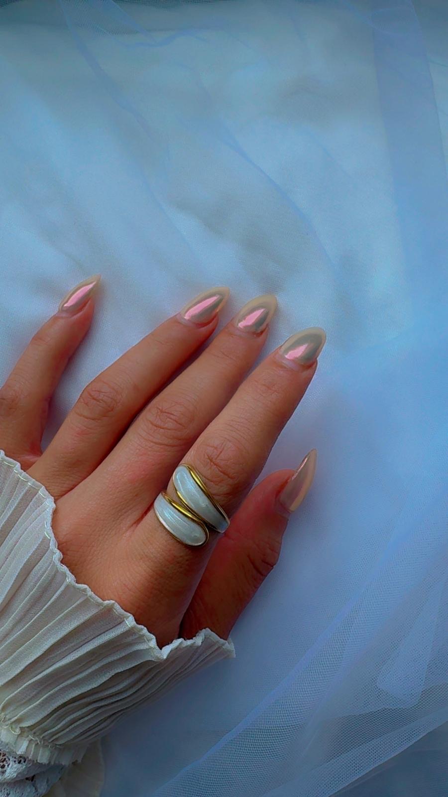 Close-up of gold ring with glossy white shell design, size 7