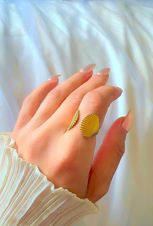 Gold seashell ring with open band design displayed on hand