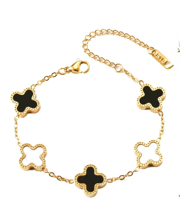 A gold-tone chain bracelet featuring five clovers 
