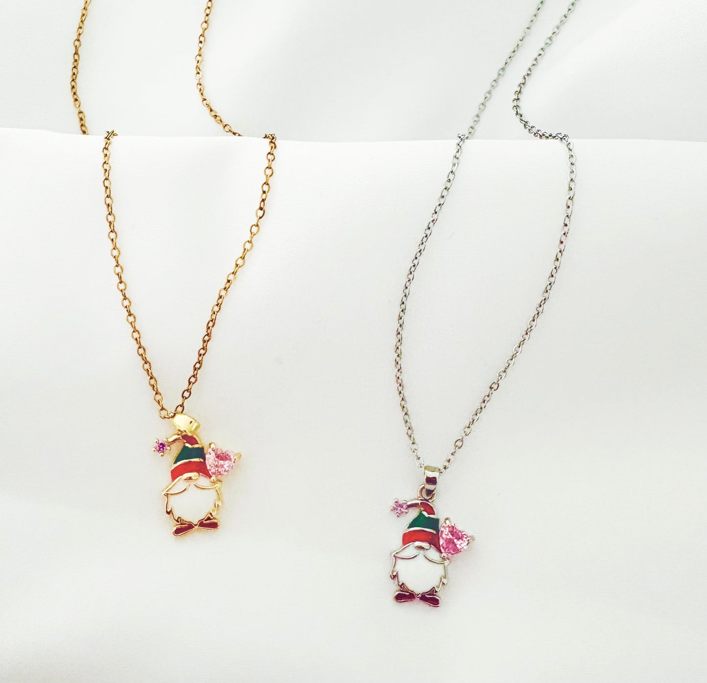 Two necklaces with gnome pendants on a white background