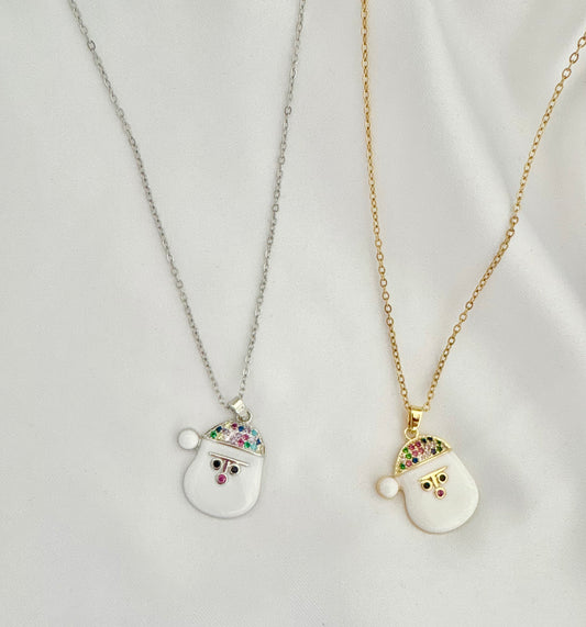 Two Santa Claus pendants on gold and silver chains against a light gray background.