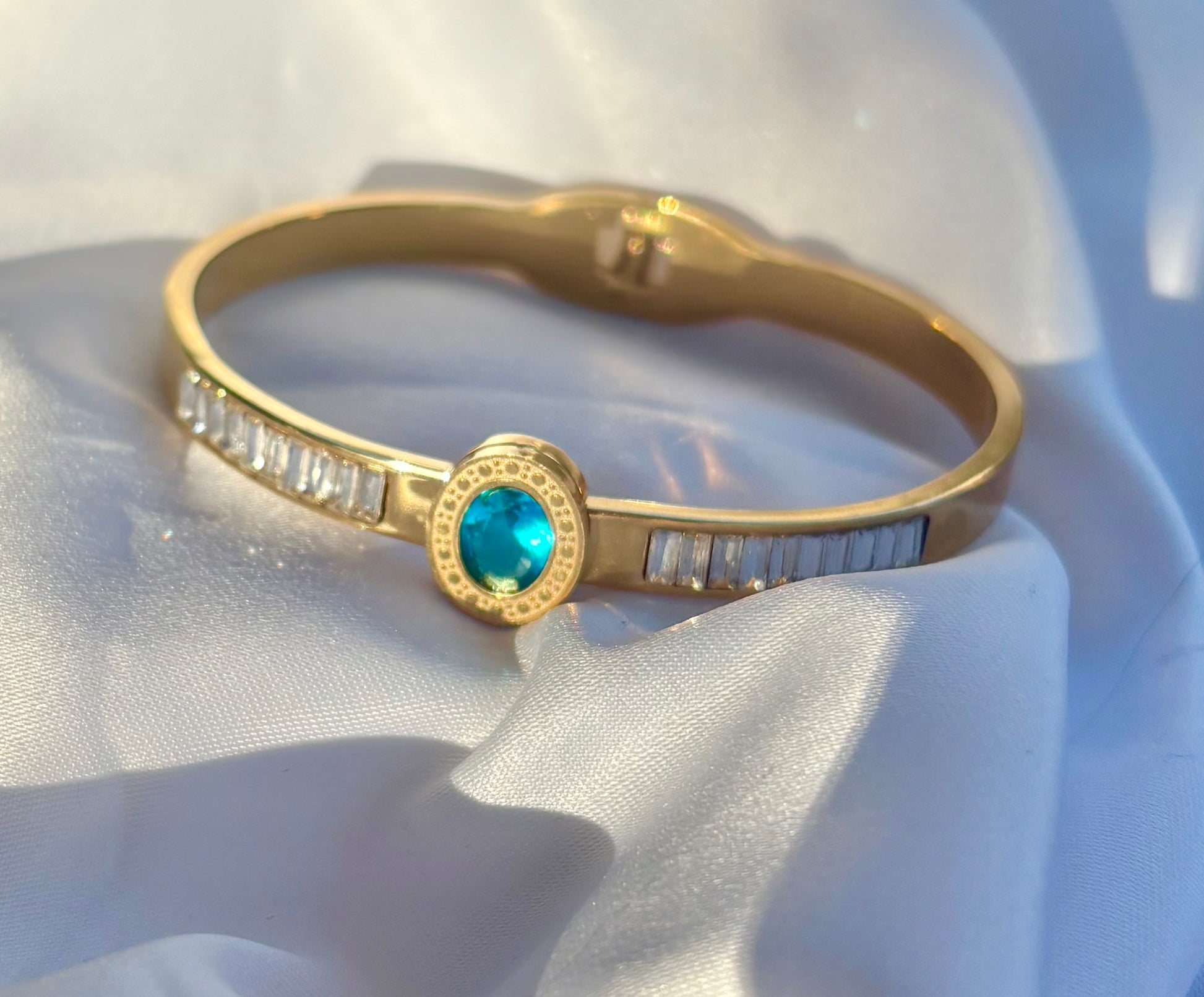 18k Gold plated bangle with a blue gemstone 