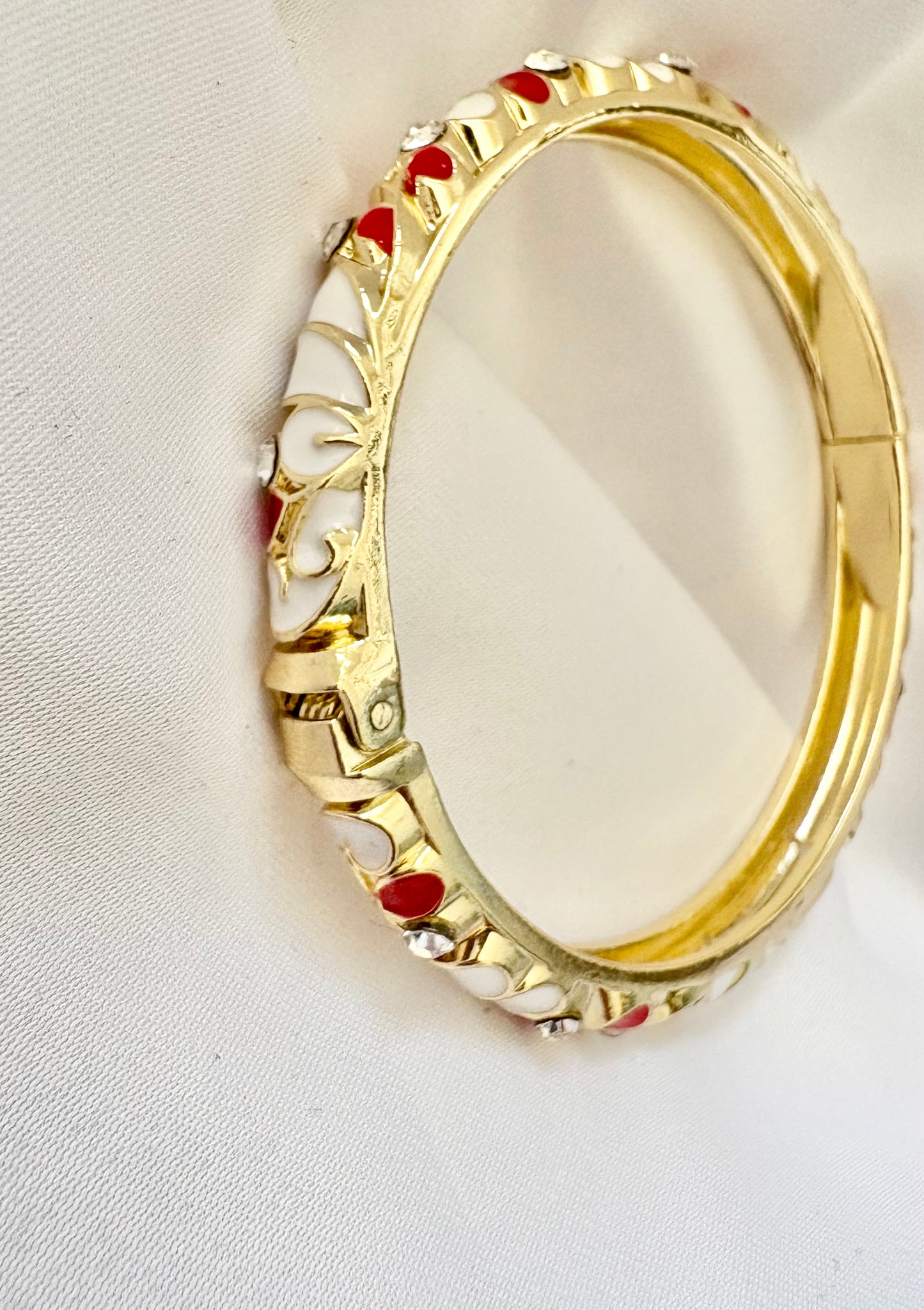 Close-up of enamel heart bangle design