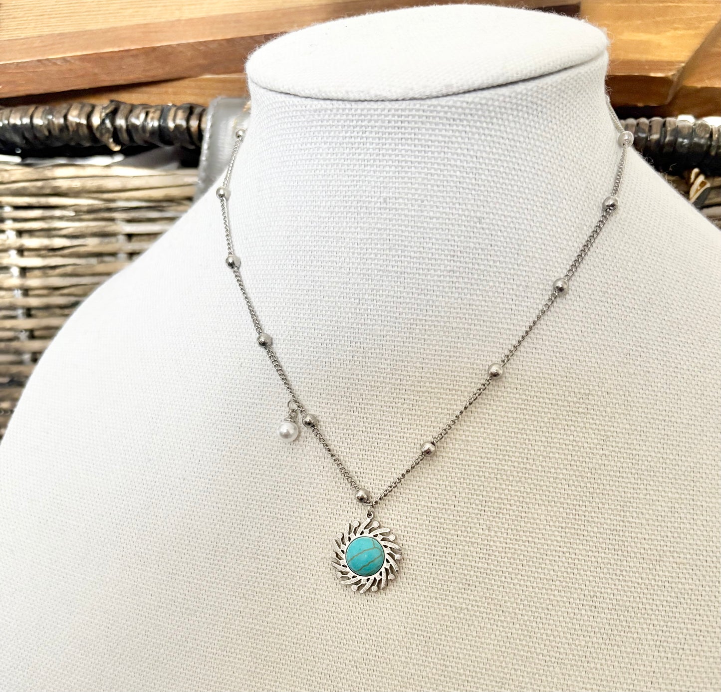 Necklace with turquoise pendant on a mannequin bust