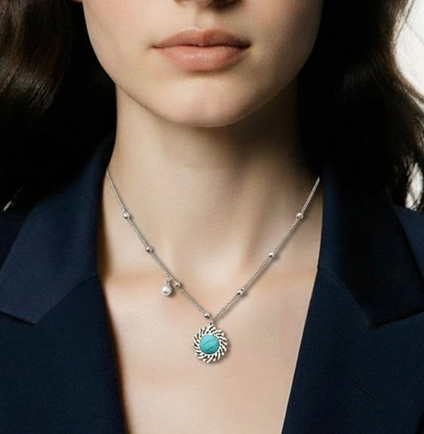 Woman wearing a necklace with a turquoise pendant