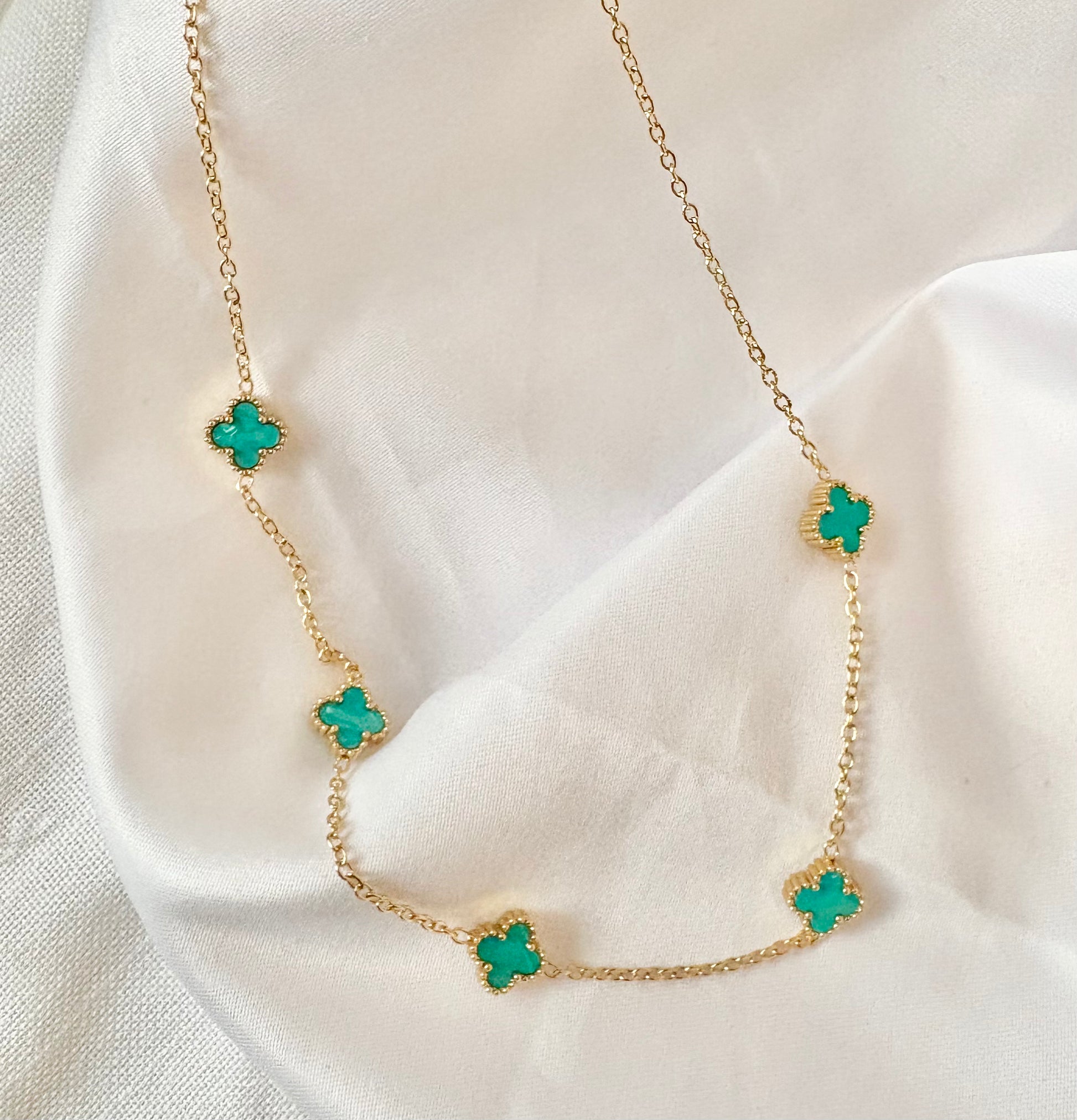 Gold chain necklace with turquoise clover charms