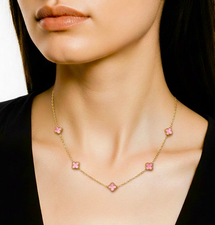 Necklace with glossy pink clover pendants worn by a model