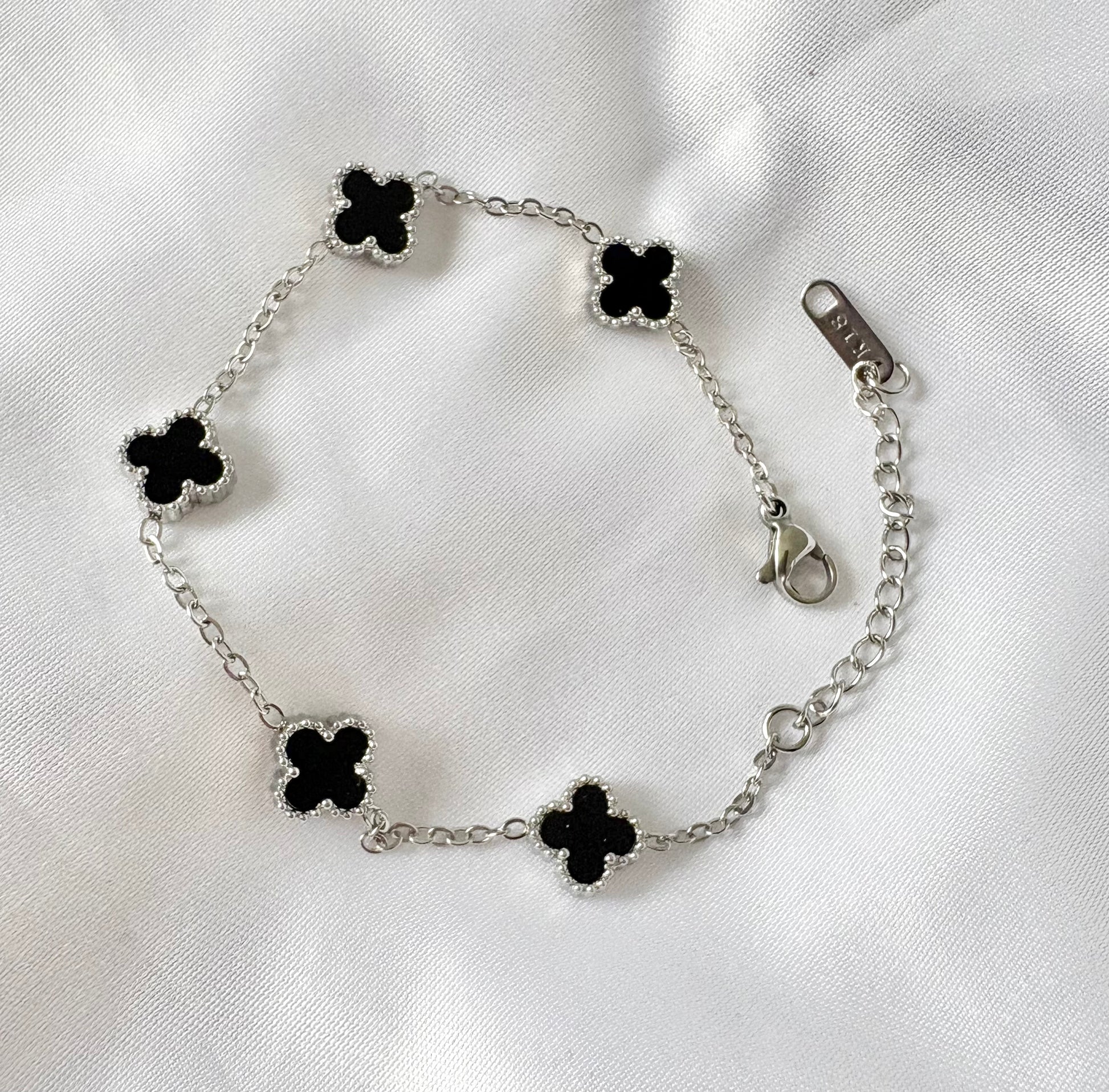 Silver bracelet with black clover charms