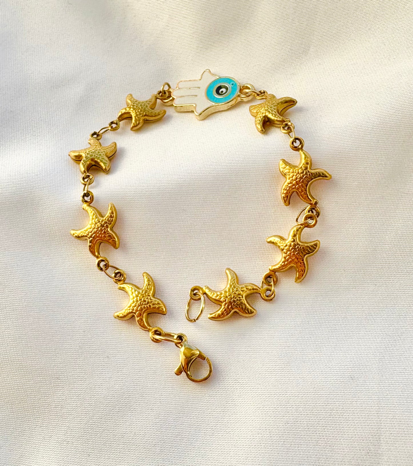 Close-up of Hamsa hand and starfish bracelet