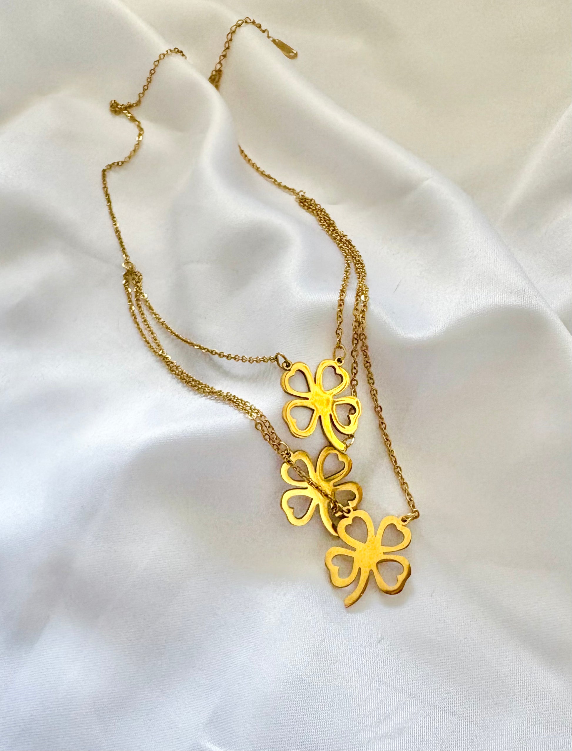 Gold layered clover necklace with three four-leaf charms