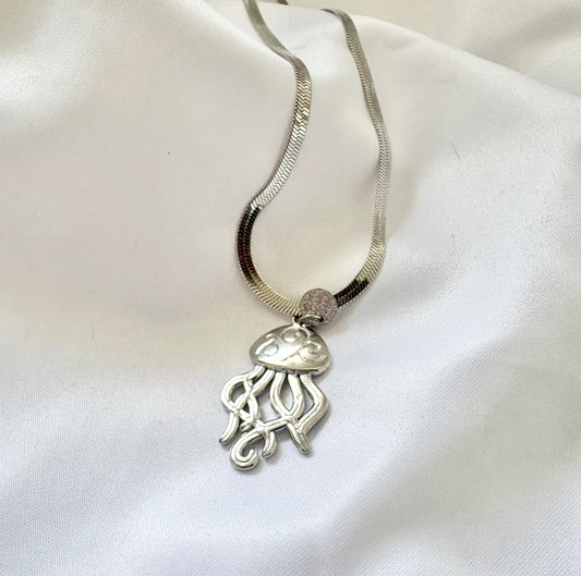Minimalist silver jellyfish necklace displayed on mannequin