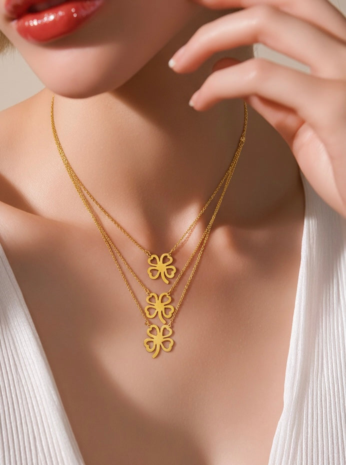 Triple clover gold necklace displayed on mannequin