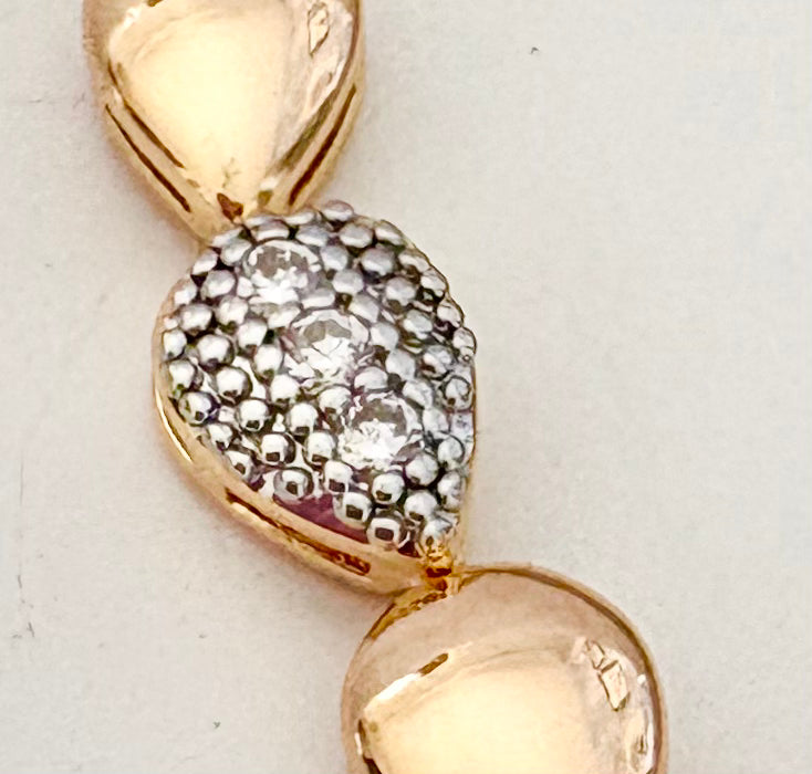 close-up picture of a gold and silver bracelet with zircon stone 