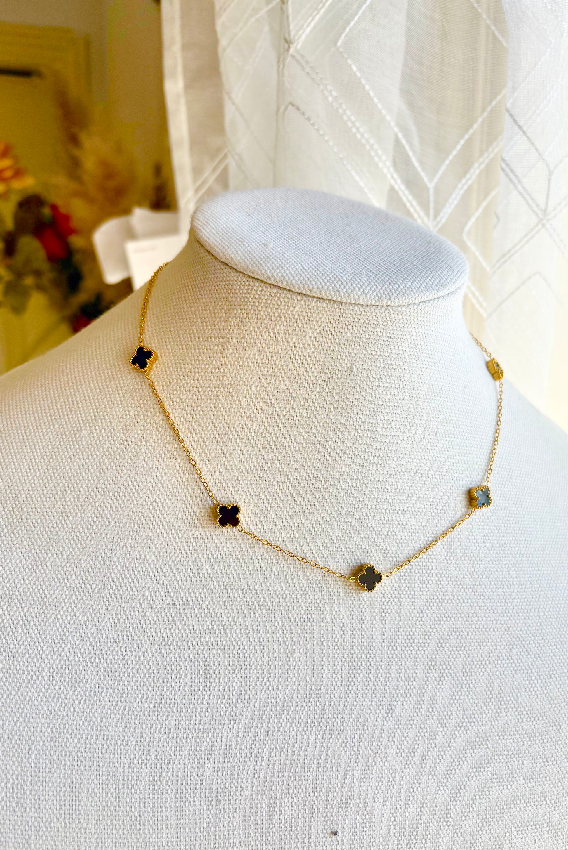 Necklace with clover-shaped pendants on a mannequin 