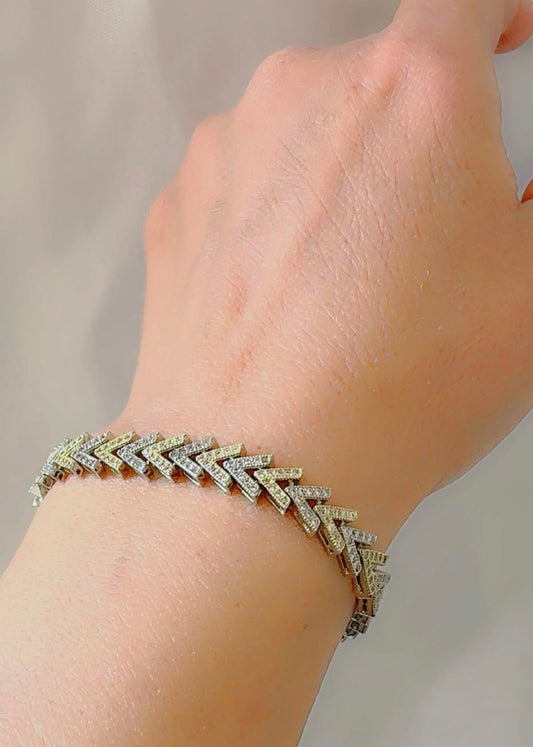 V Shape bracelet on a wrist with a neutral background