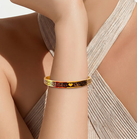 Gold bracelet with Arabic Calligraphy designs on a person's wrist 