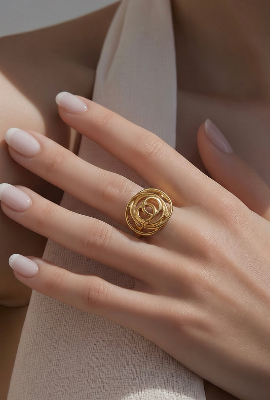 Gold ring on a hand with beige background