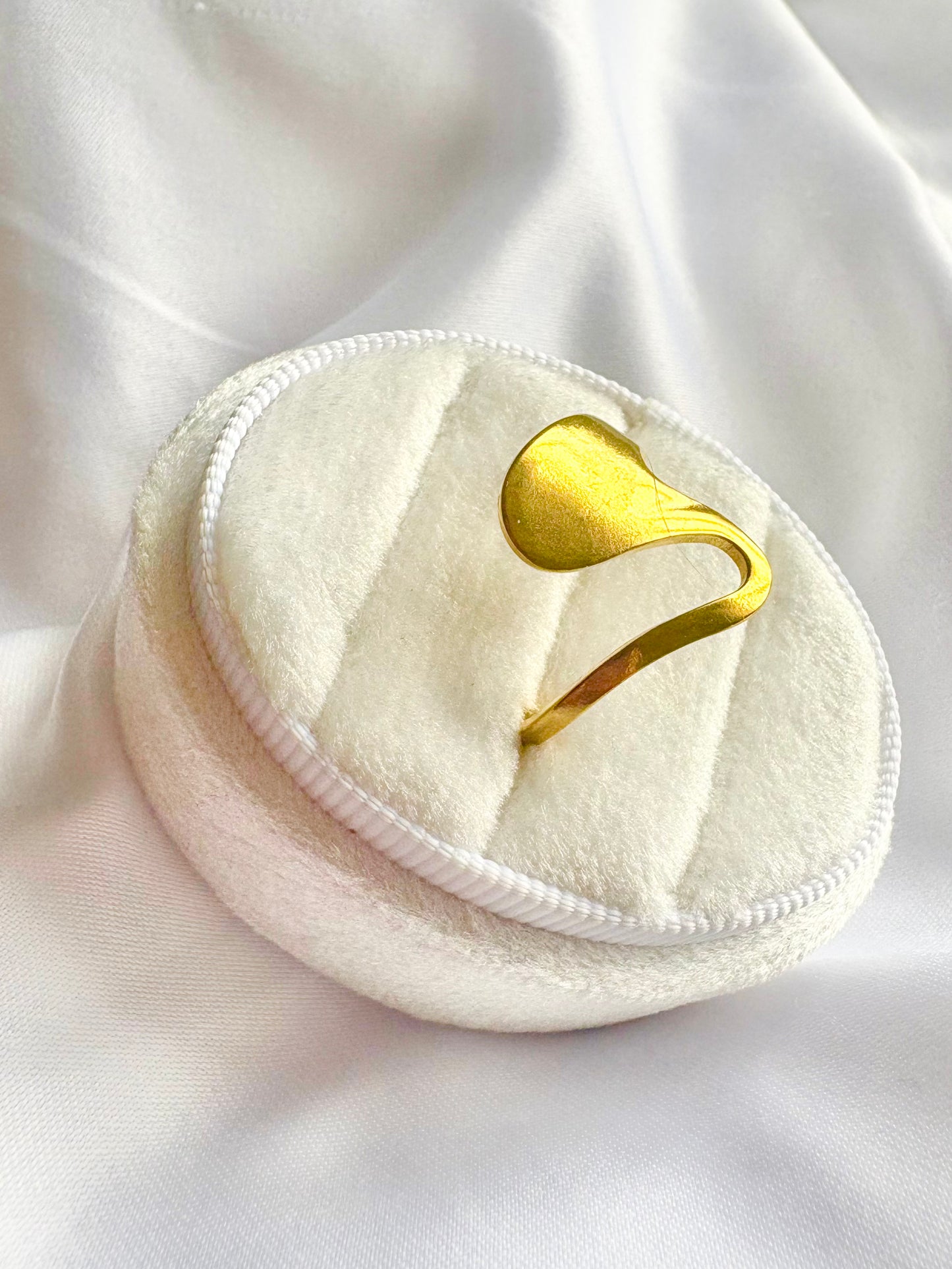 Gold ring on a white cotton pad