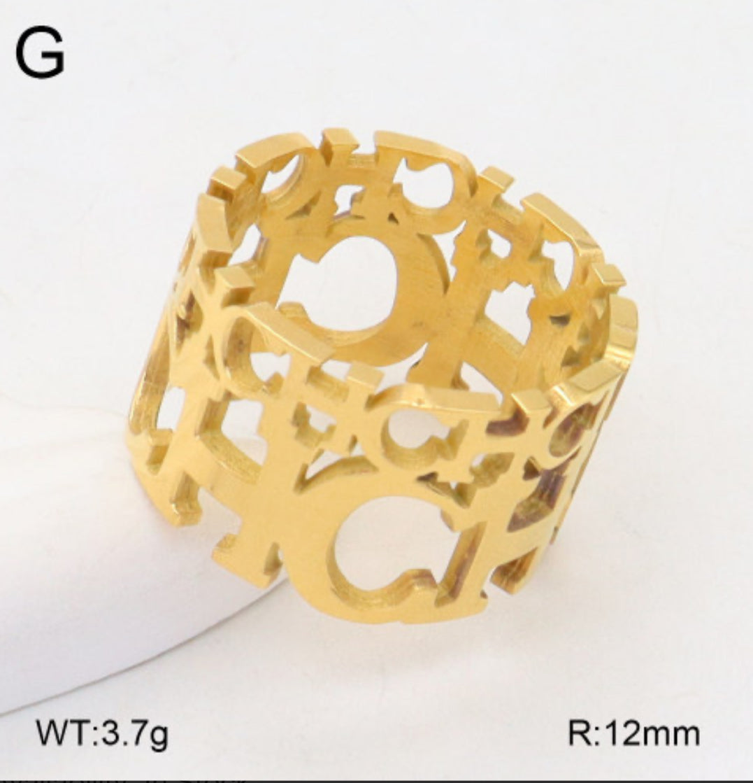 Gold bracelet with intricate design on a white background