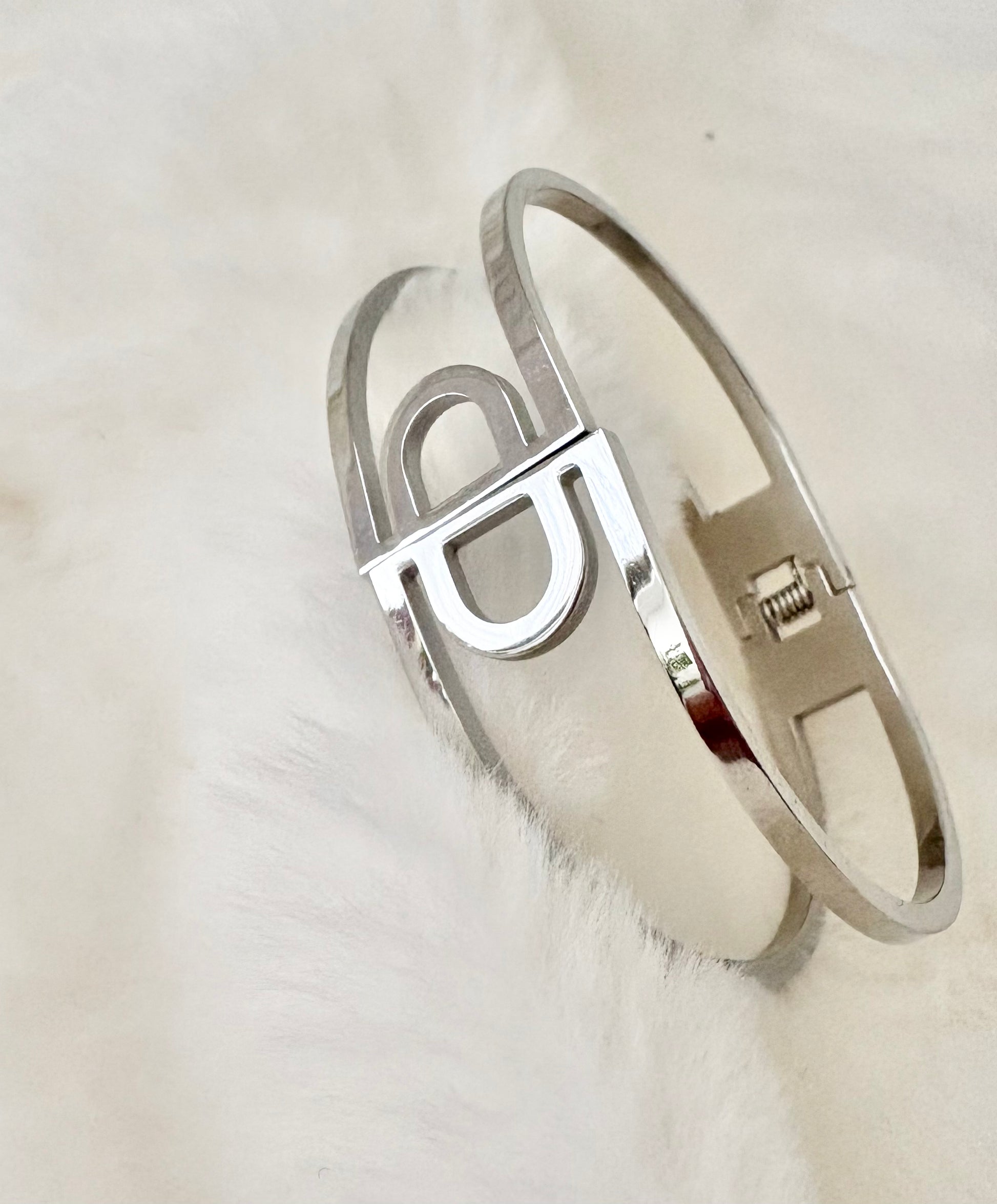 Silver bracelet with CD design on a white background