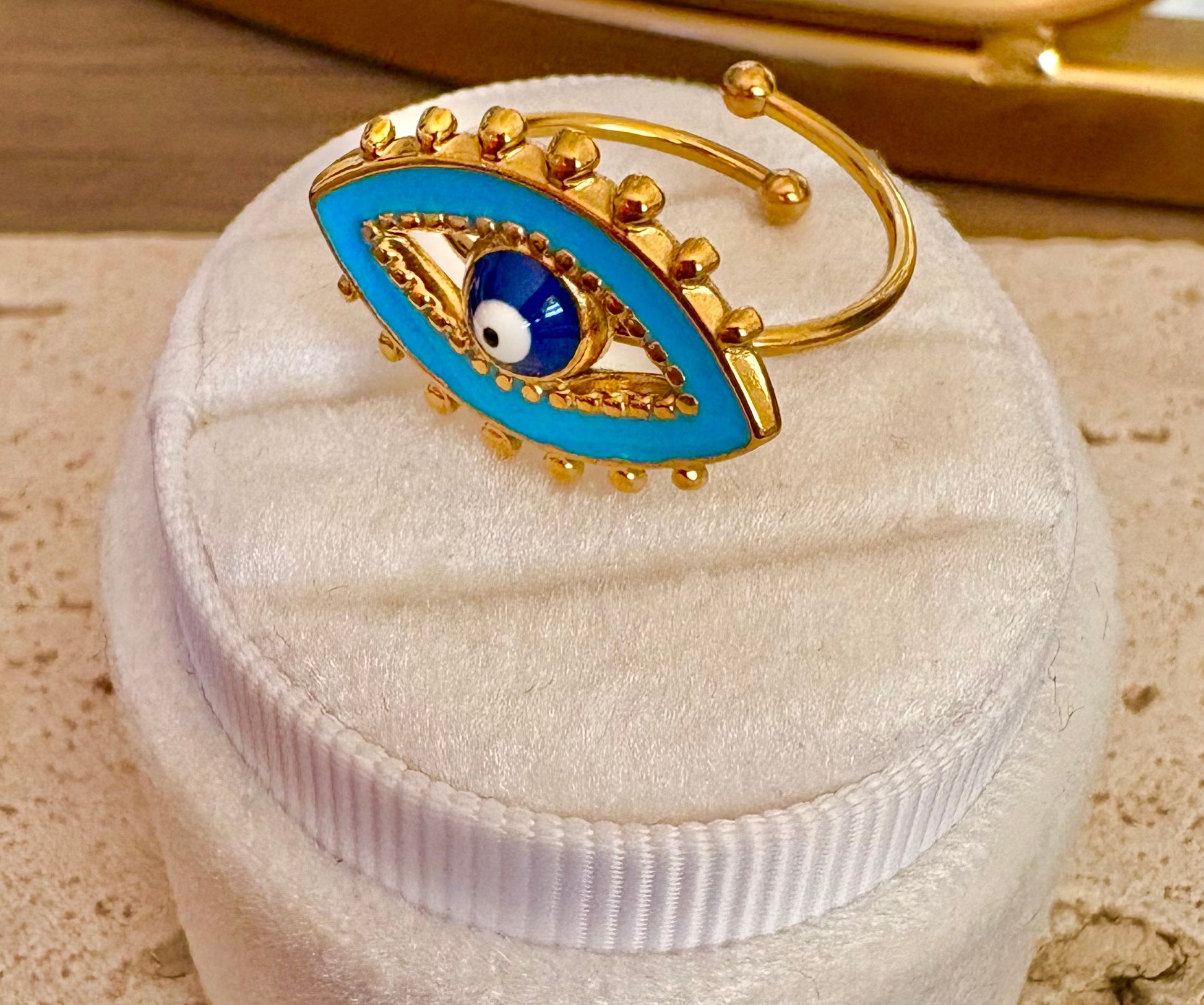 Gold-plated evil eye open cuff ring with turquoise blue enamel and a central white and blue evil eye motif