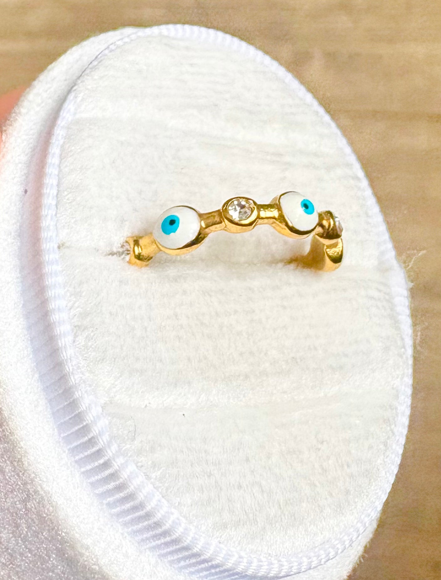 A gold ring with 6 evil eyes and 5 zircon stones
