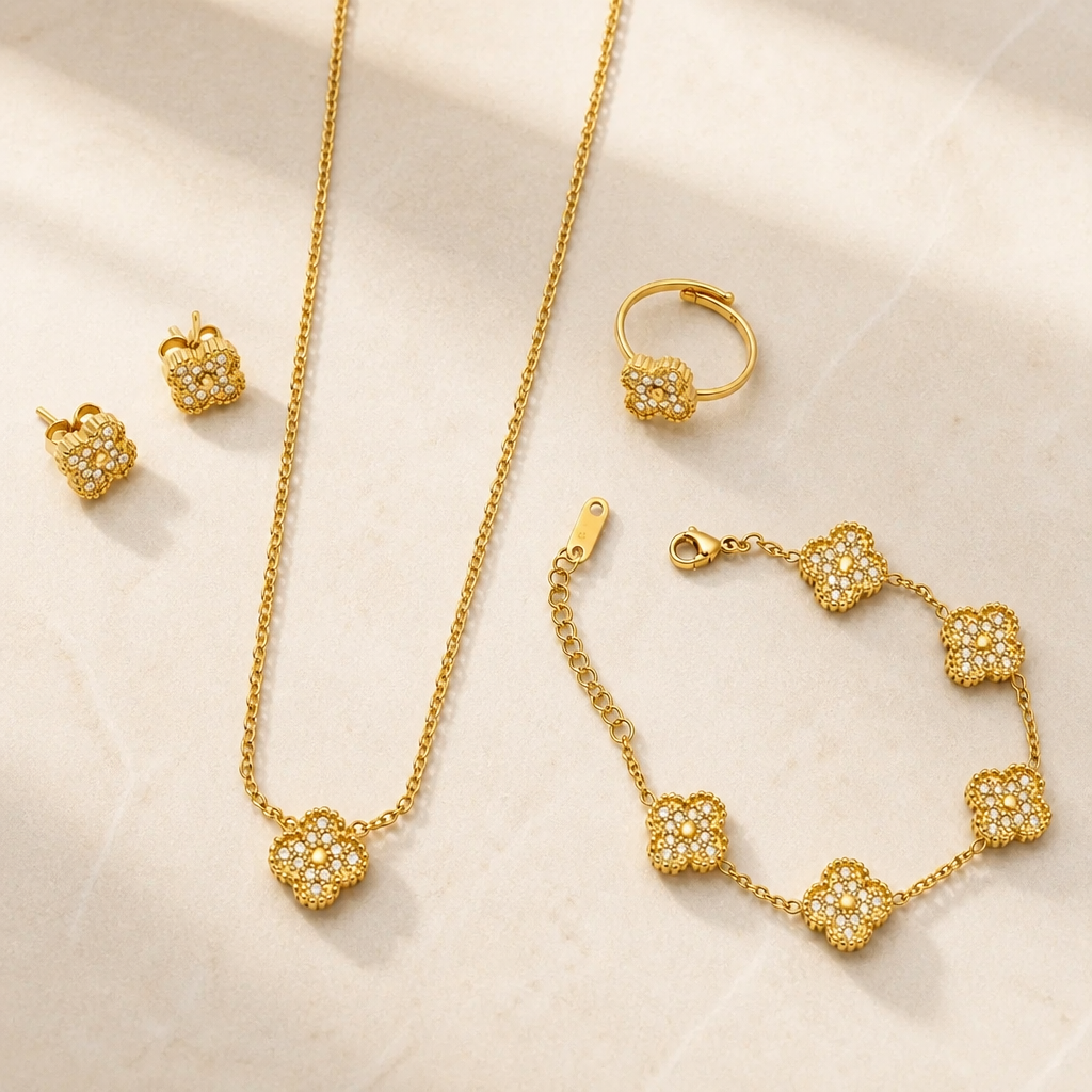 A gold jewelry set including a necklace, bracelet, earrings, and ring
