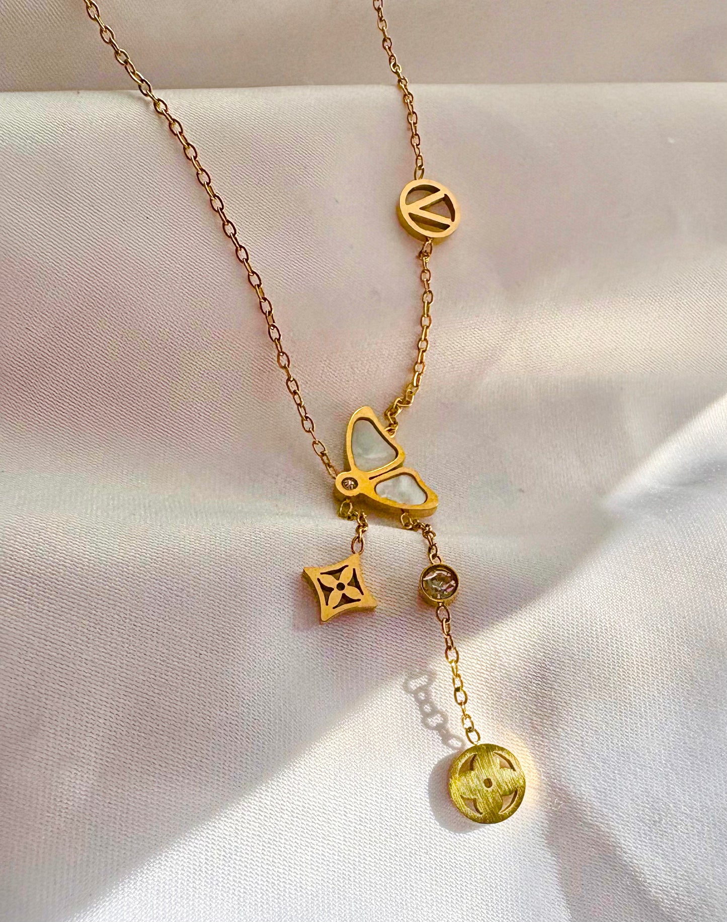 A gold-tone chain necklace with multiple charms