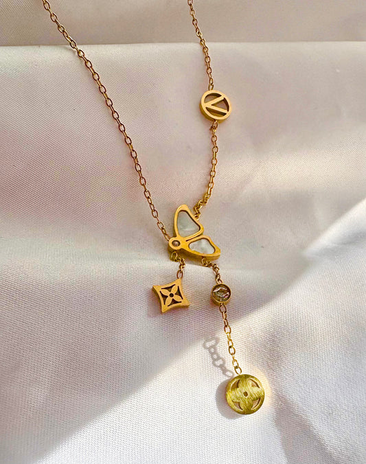 A gold-tone chain necklace with multiple charms
