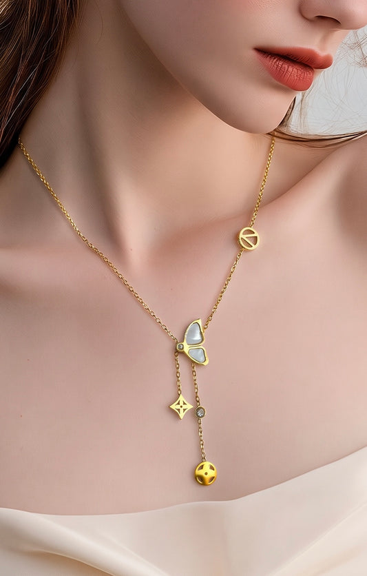  A delicate gold necklace with a butterfly pendant, a peace sign charm, and a dangling charm featuring a small gold sun.