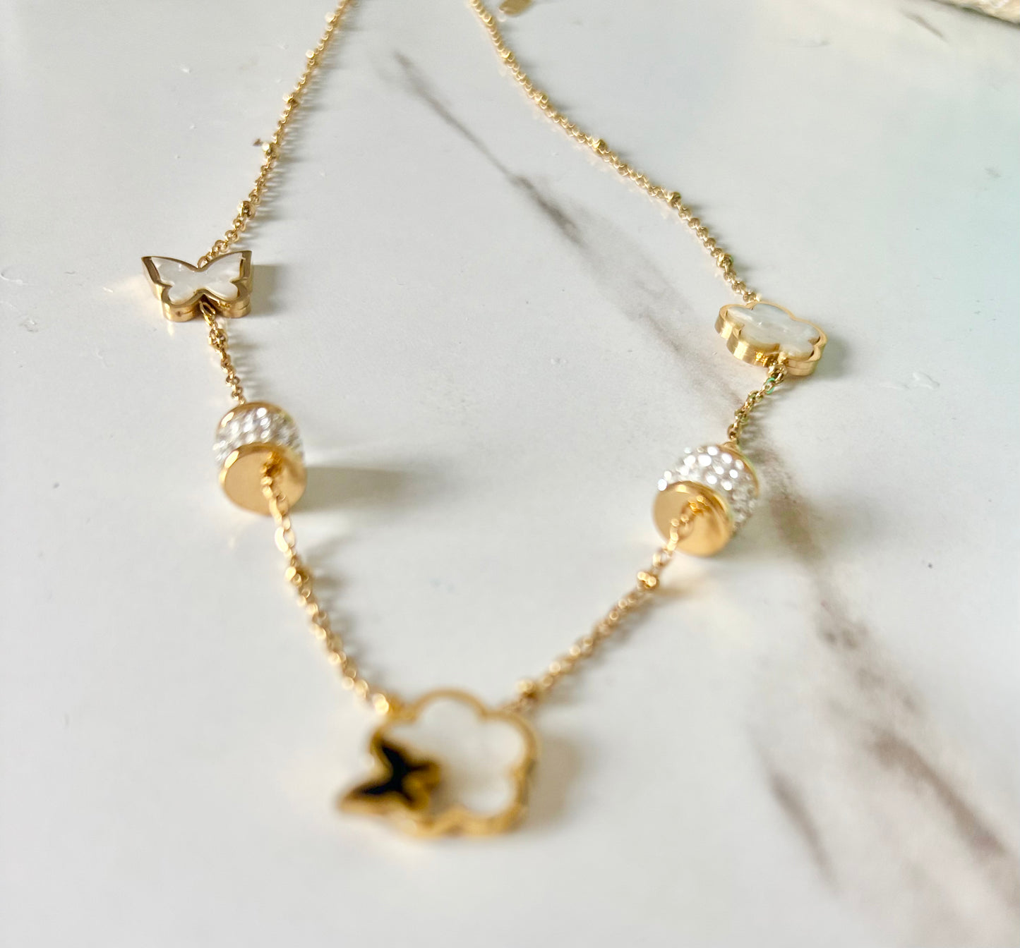 A delicate gold chain necklace with butterfly