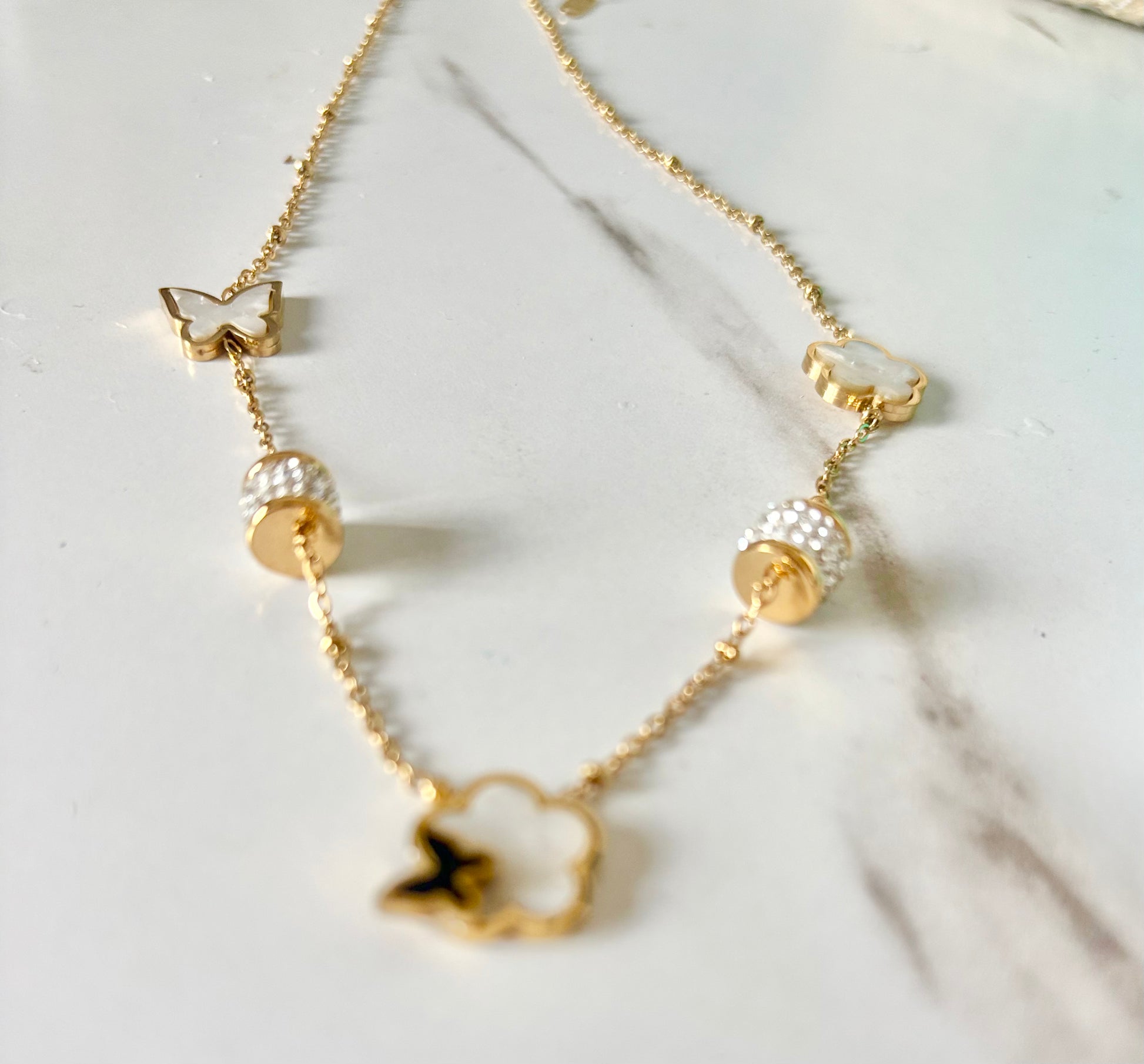 A delicate gold chain necklace with butterfly