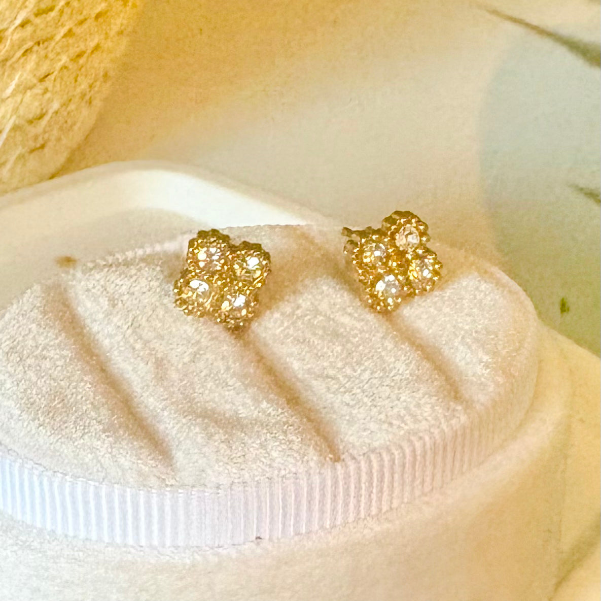 A pair of gold-toned stud earrings with zircon stones