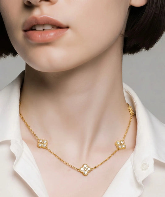 A close-up of a model wearing a delicate gold chain necklace 