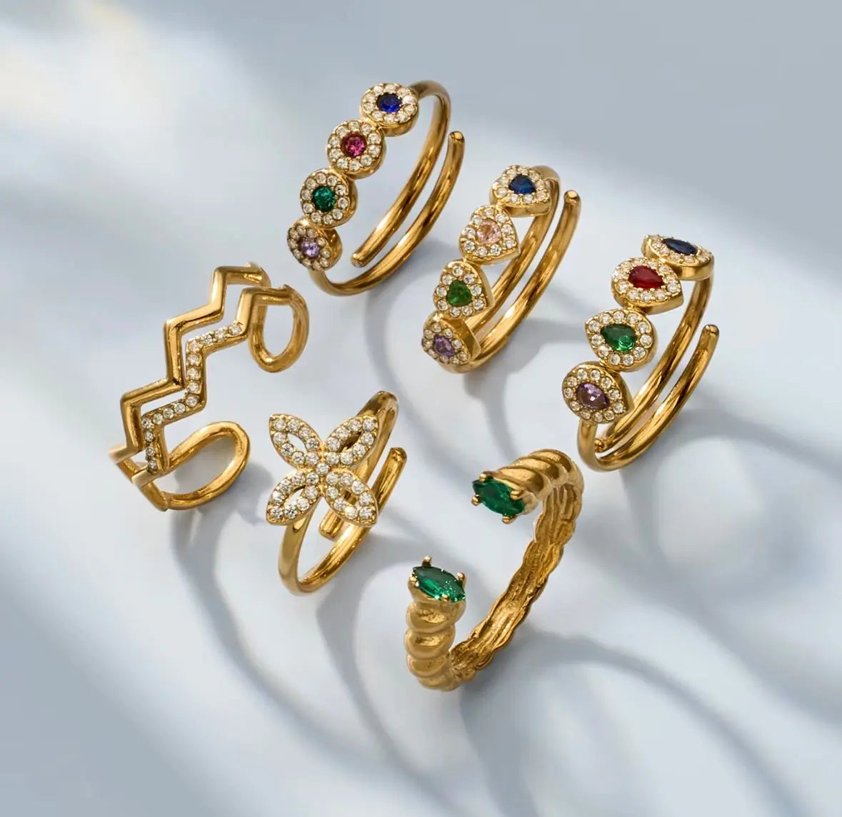 Six gold rings with colorful zircon gemstones and clear zircon