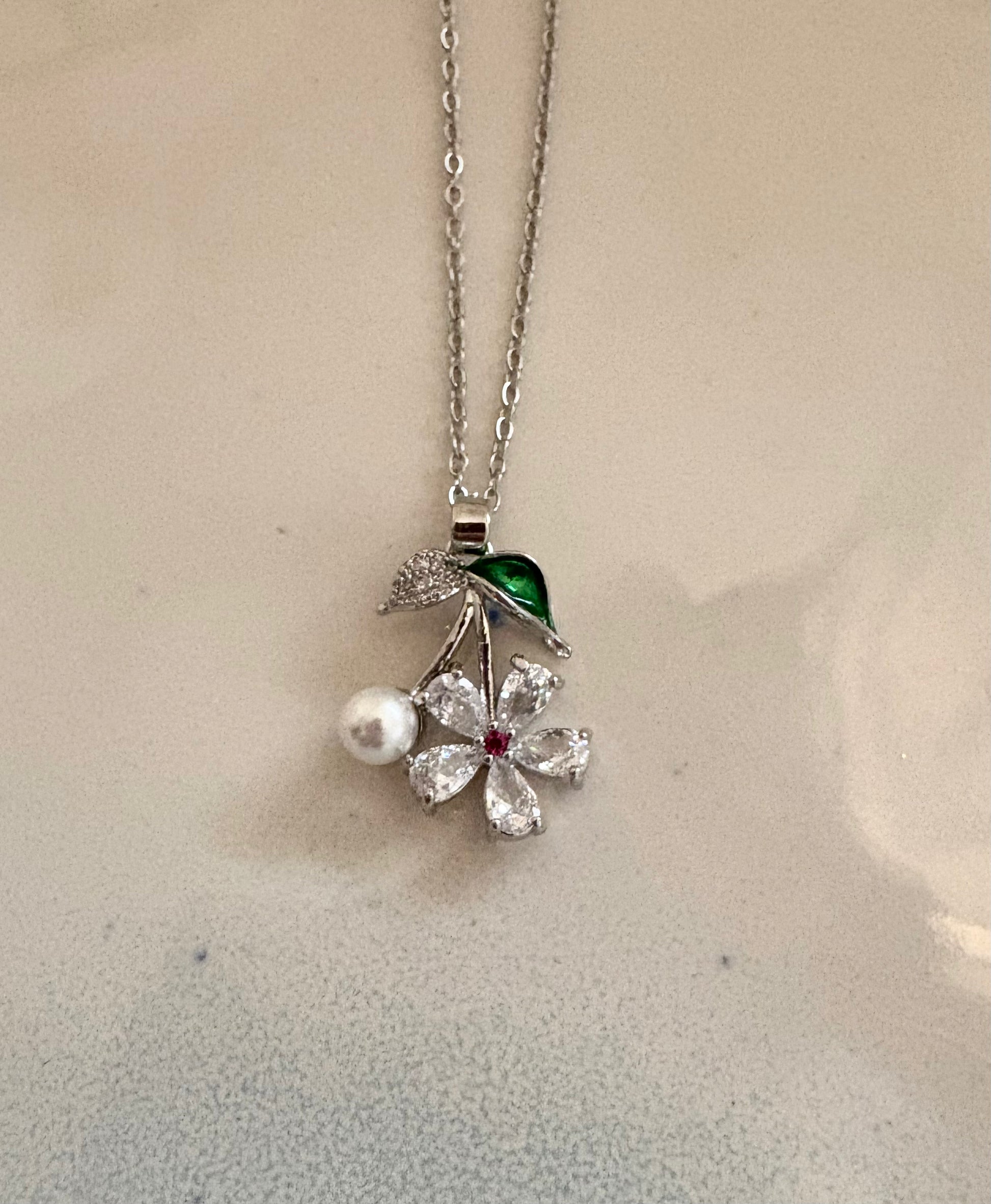 Silver floral pendant necklace with pearl and crystal details