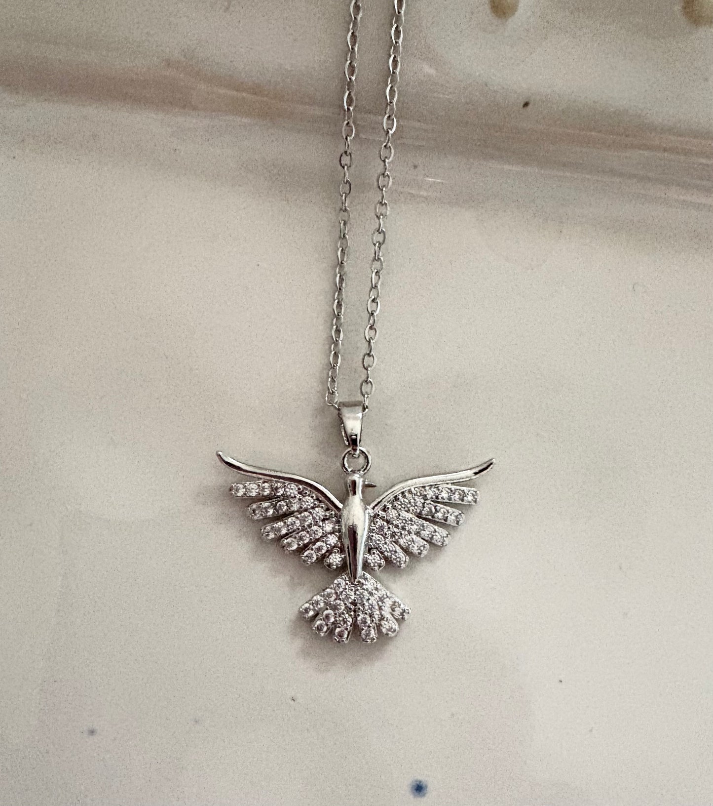 Silver dove pendant necklace with crystal wings on gold chain