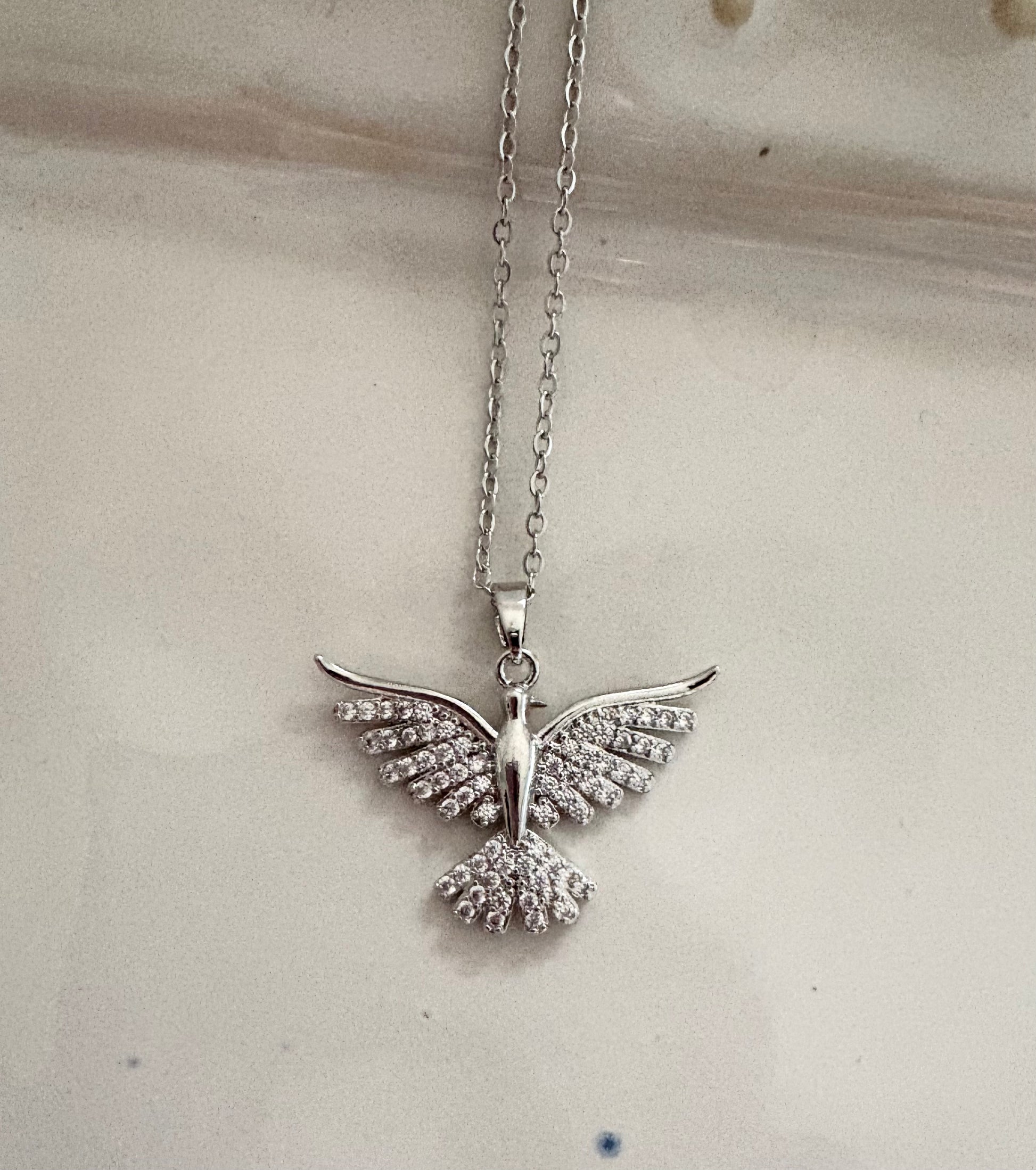 Silver dove pendant necklace with crystal wings on gold chain