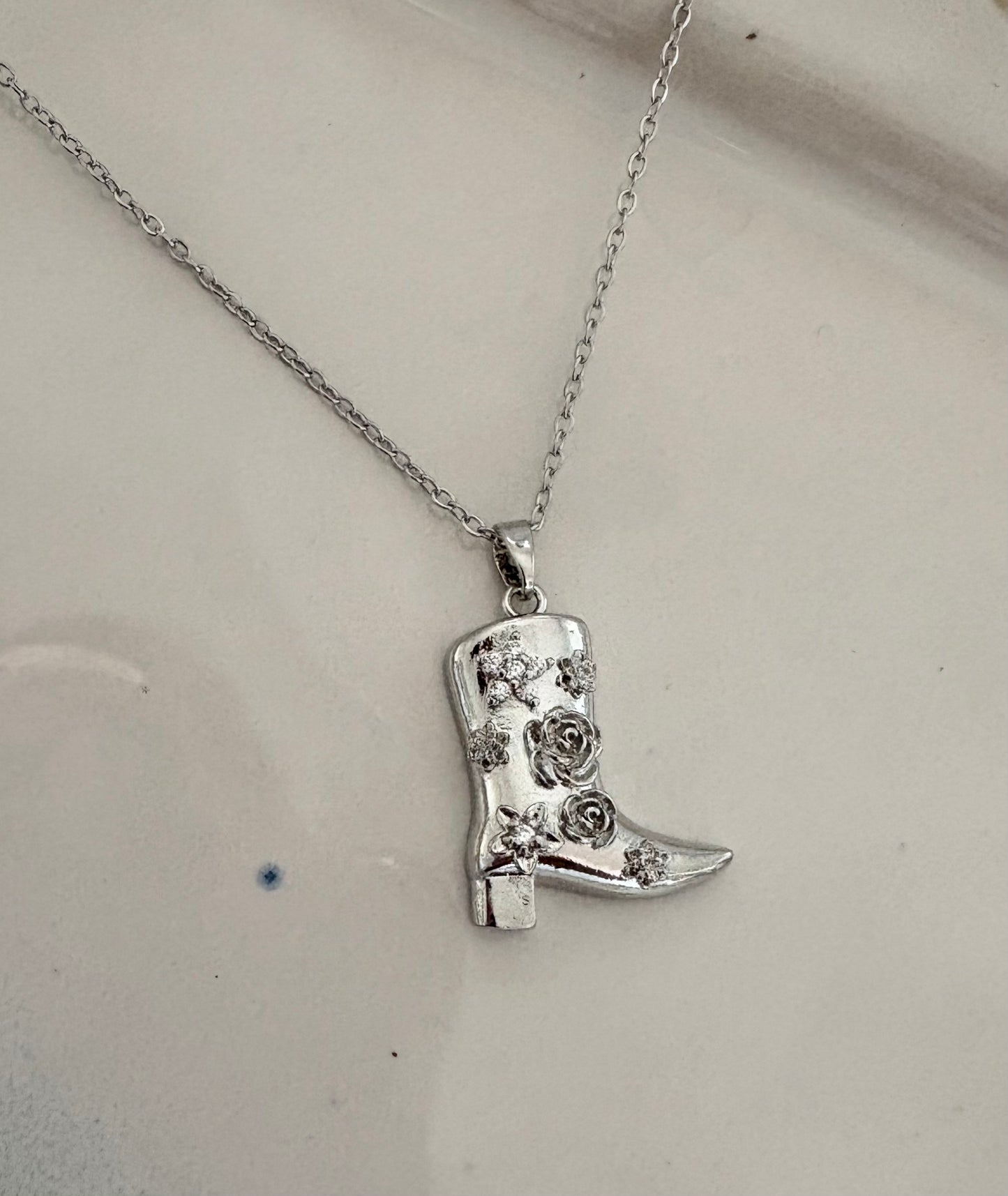 Silver cowboy boot necklace with crystal floral design
