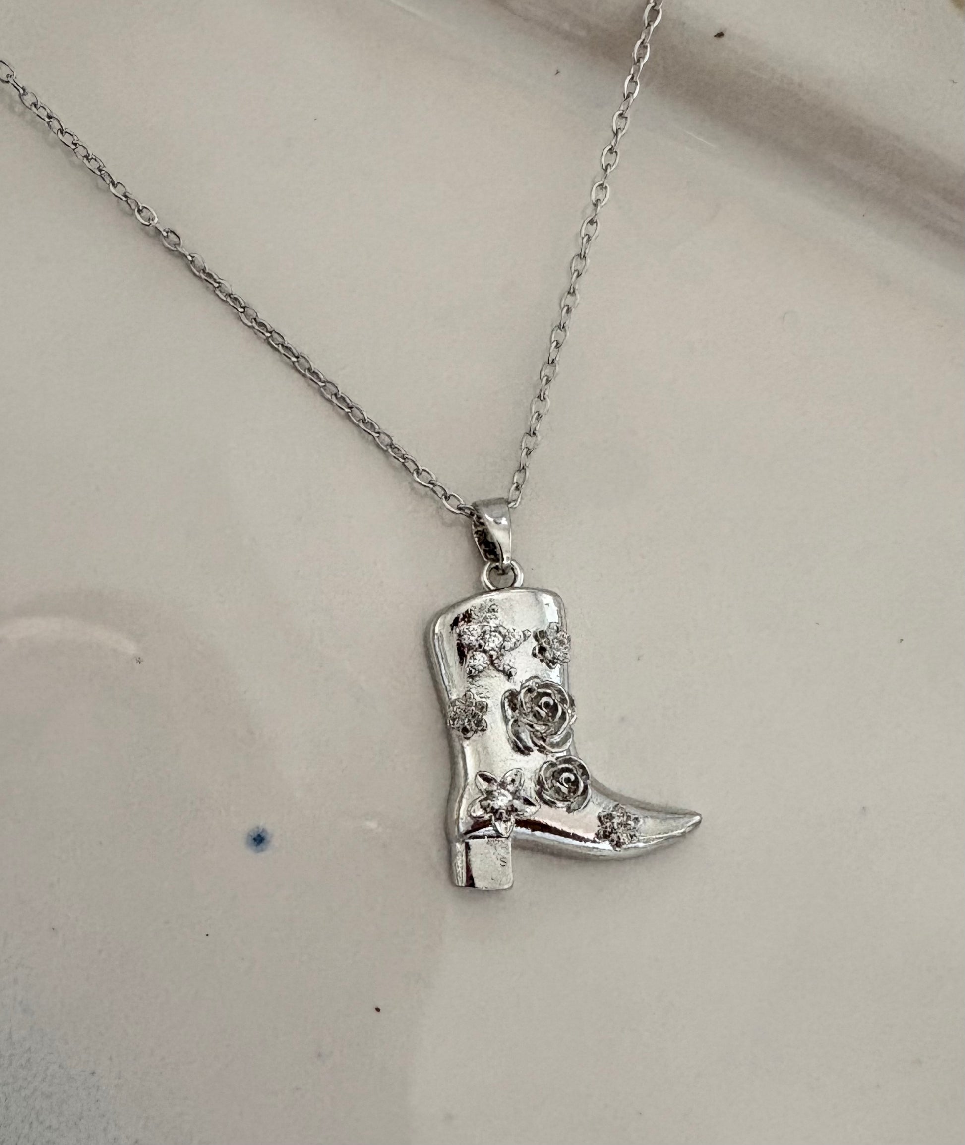 Silver cowboy boot necklace with crystal floral design