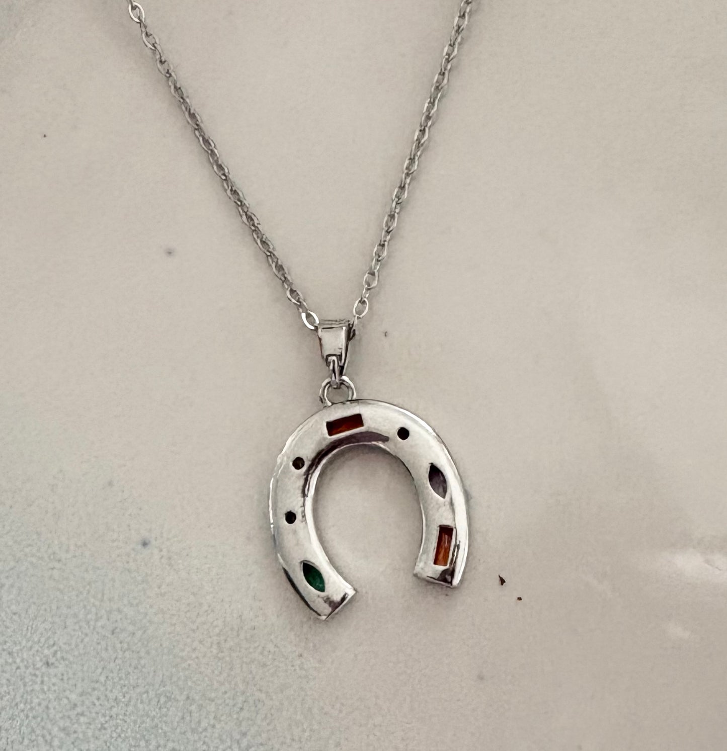 Silver horseshoe pendant necklace with multicolor crystal accents