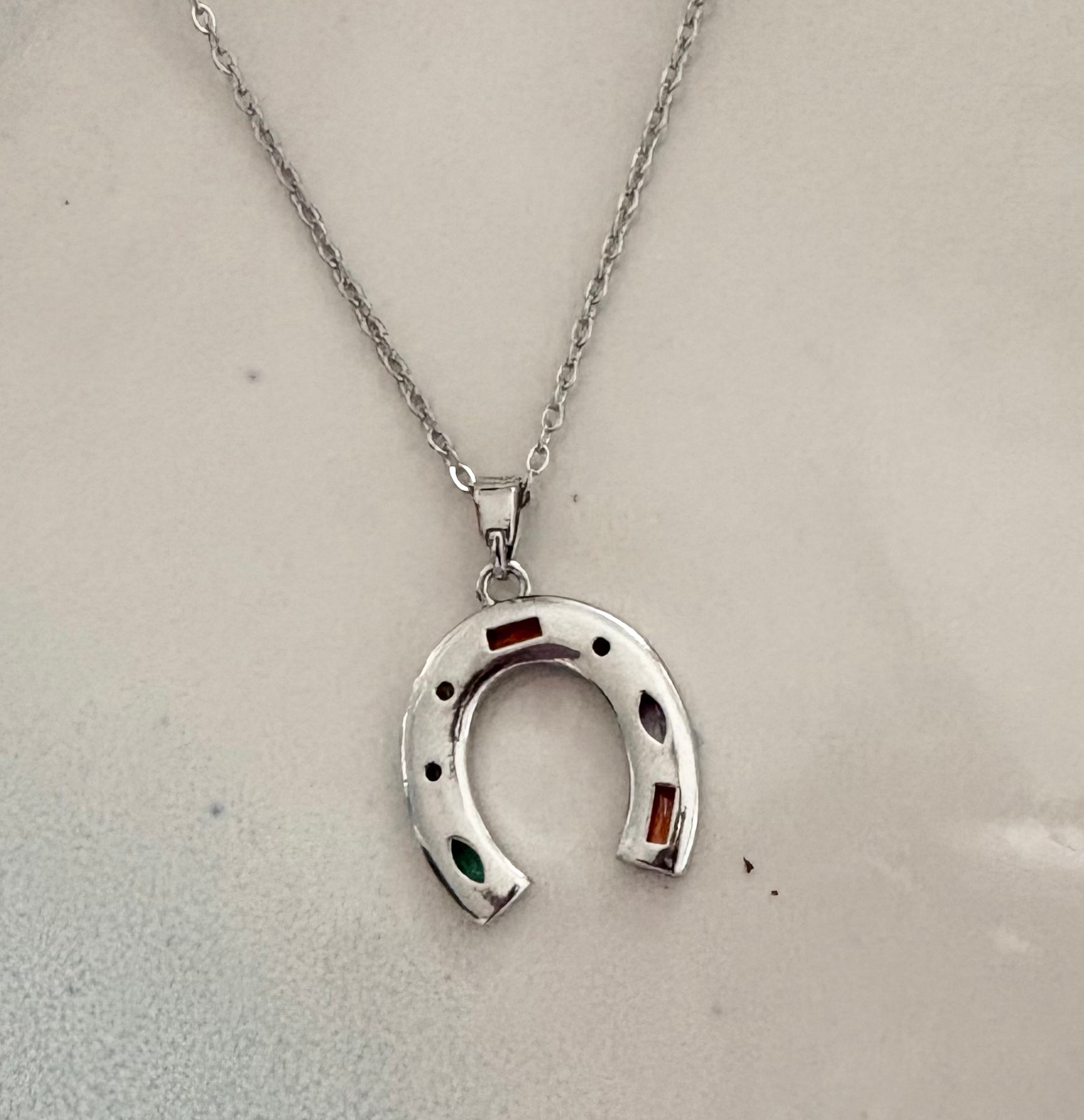 Silver horseshoe pendant necklace with multicolor crystal accents