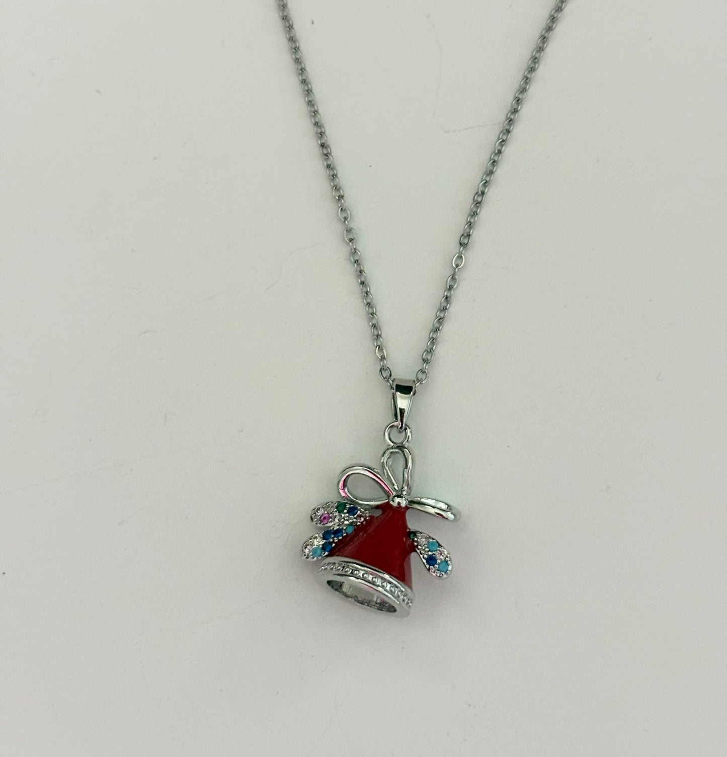 Necklace with a red bell and bow pendant 