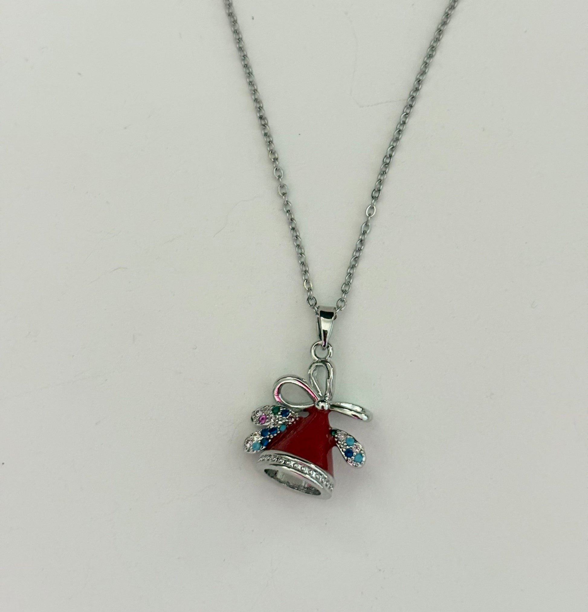 Necklace with a red bell and bow pendant 