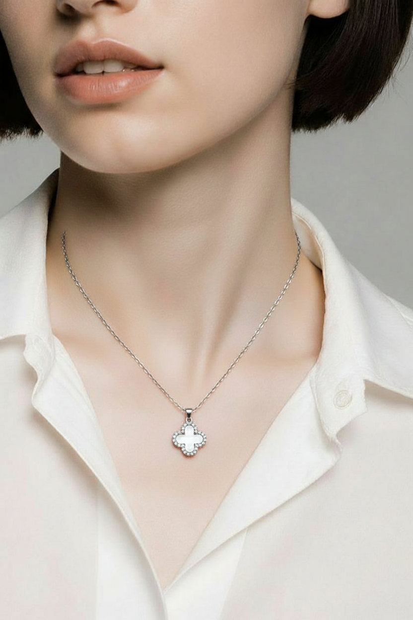 Dainty white clover charm necklace with adjustable 40–45cm chain.